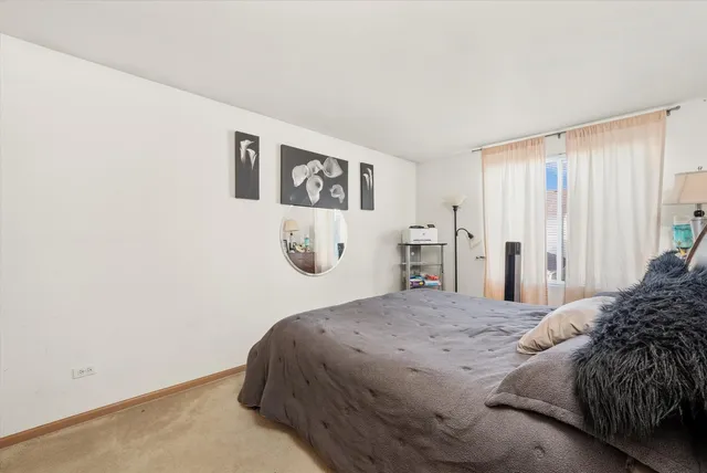 a bedroom with a bed and a wall painting