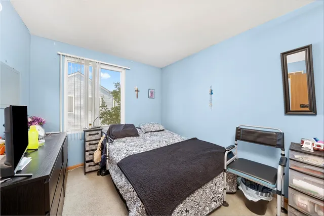 a bedroom with a bed work place and a desk