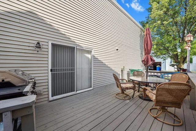 a view of a roof deck with table and chairs and wooden floor