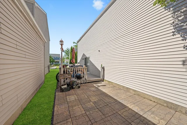 a view of a chair and tables in the backyard of the house