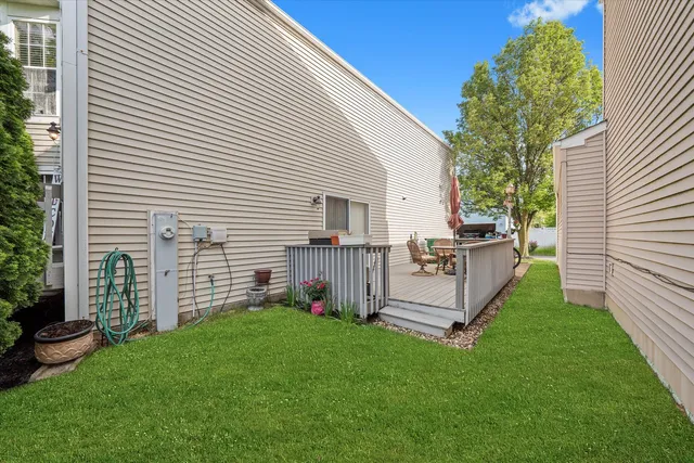 a view of backyard with barbeque grill and a wooden fence