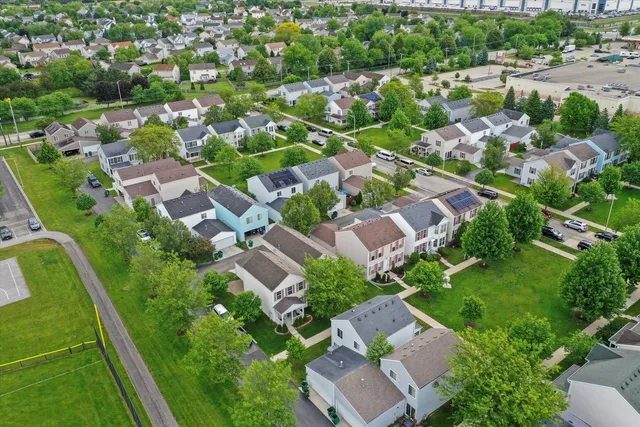 an aerial view of residential houses with outdoor space and river