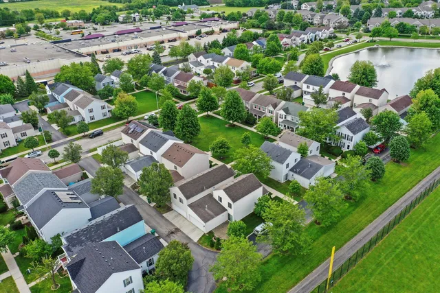 an aerial view of residential house with outdoor space and lake view