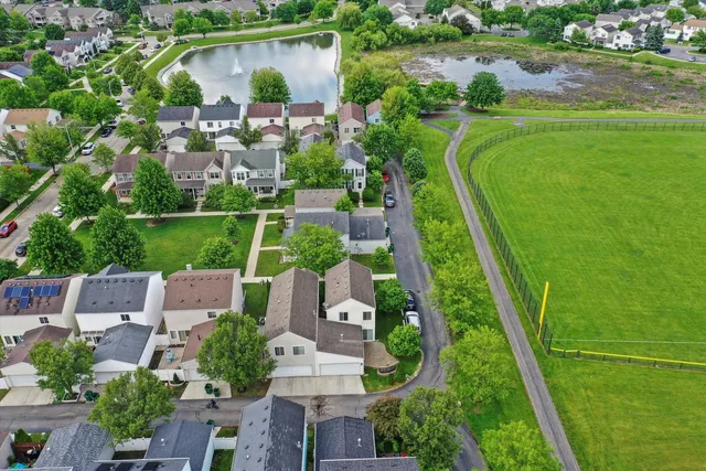 an aerial view of residential houses with outdoor space and swimming pool