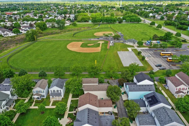 an aerial view of a houses with outdoor space and street view