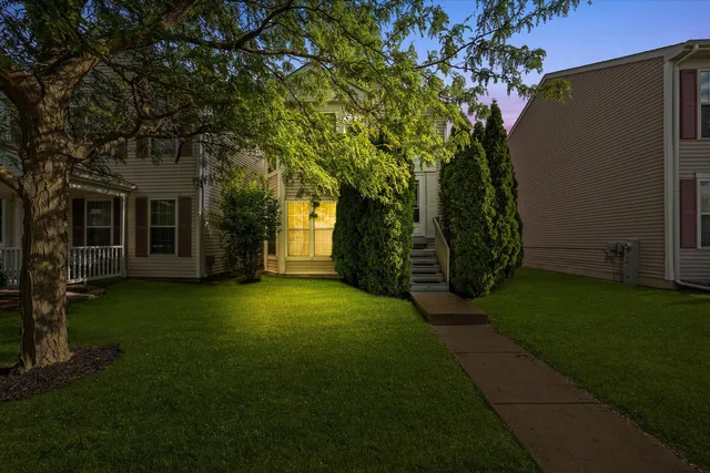 a front view of a house with a garden