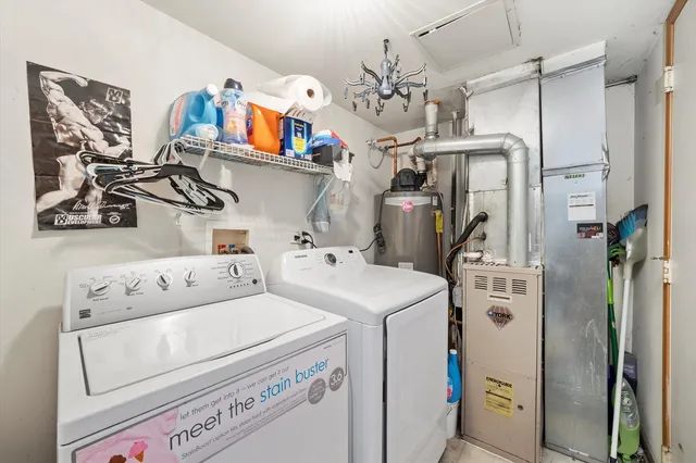 a view of washer and dryer with kitchen in the background