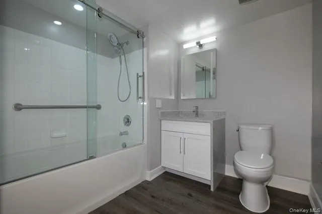 a bathroom with a toilet sink and shower