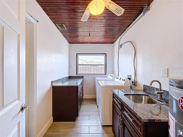a kitchen with granite countertop a sink and cabinets