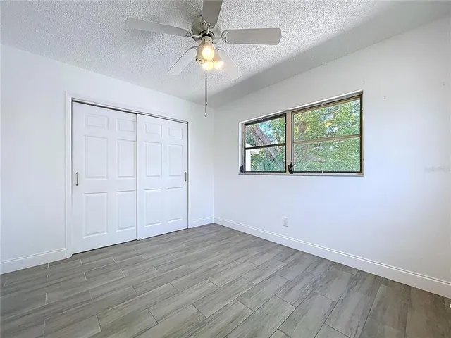 a view of a lake with boats and trees in the background
