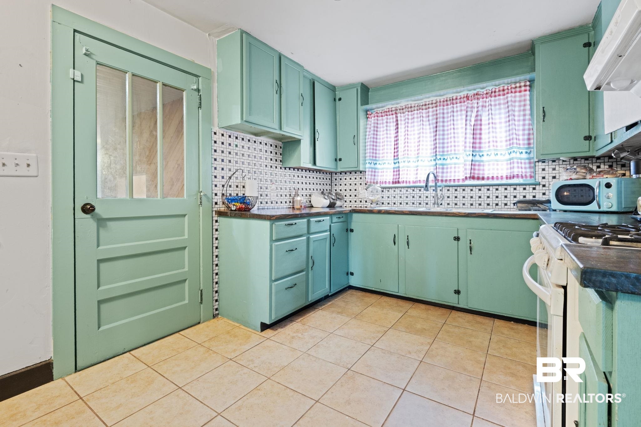 305 Alpine Street Mobile, AL 36611 - Photo 7 of 21 Kitchen with ventilation hood, white gas range, and green cabinets