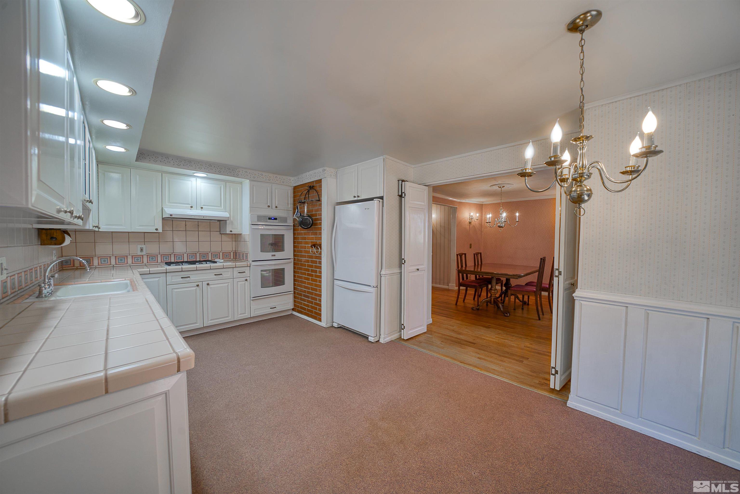 1730 West 6th Street Reno, NV 89503 - Photo 12 of 25 a view of a kitchen with refrigerator and cabinets