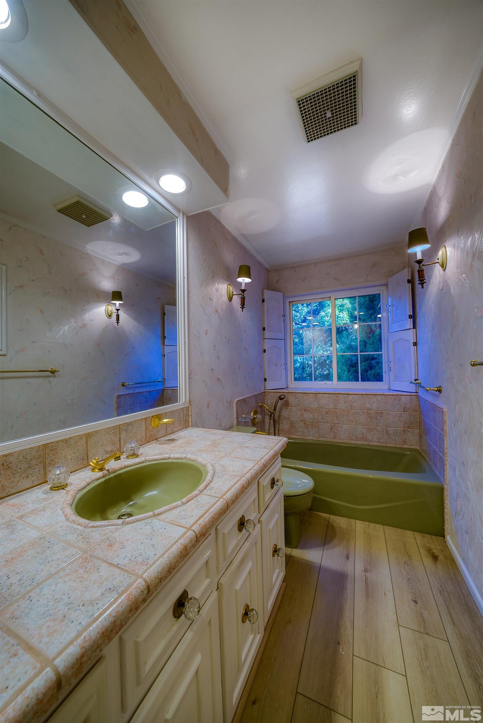 1730 West 6th Street Reno, NV 89503 - Photo 16 of 25 a bathroom with a sink a large mirror and a bathtub