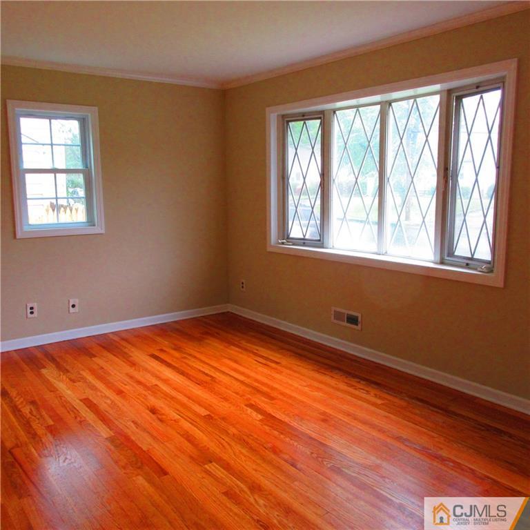 19 North Pennington Road New Brunswick, NJ 08901 - Photo 2 of 10 a view of an empty room with wooden floor and a window