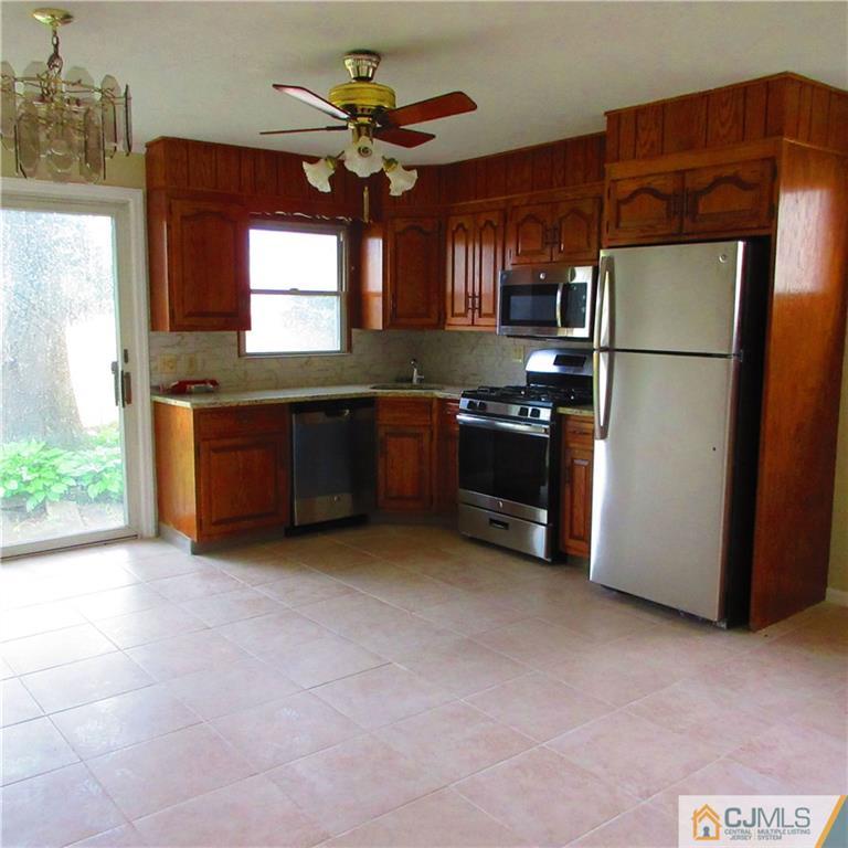 19 North Pennington Road New Brunswick, NJ 08901 - Photo 3 of 10 a kitchen with stainless steel appliances granite countertop a refrigerator a sink a stove and a refrigerator