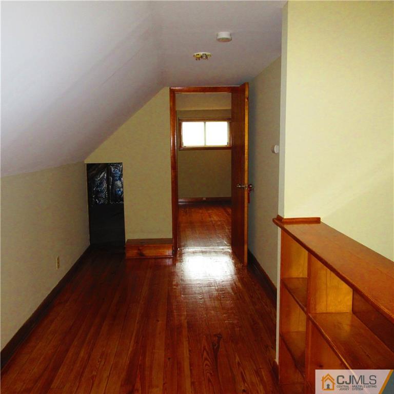 19 North Pennington Road New Brunswick, NJ 08901 - Photo 6 of 10 a view of a hallway with wooden floor and stairs