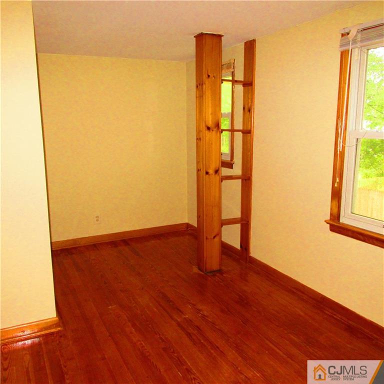 19 North Pennington Road New Brunswick, NJ 08901 - Photo 7 of 10 a view of an empty room with wooden floor and a window