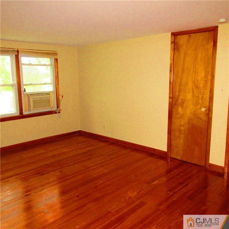 19 North Pennington Road New Brunswick, NJ 08901 - Photo 8 of 10 a view of an empty room with wooden floor and a window