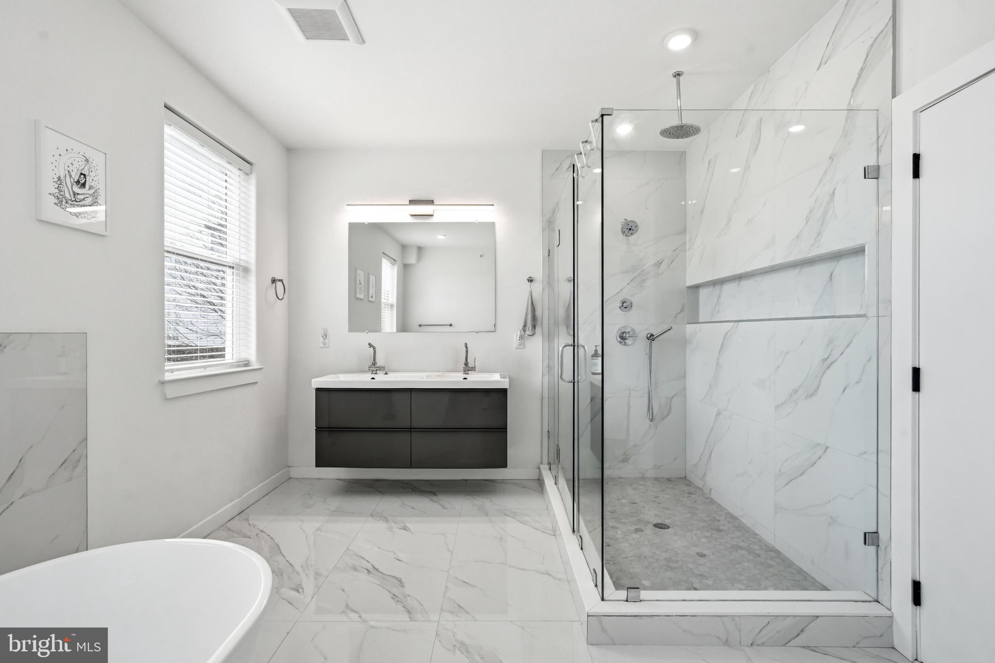 2604 Reed Street Philadelphia, PA 19146 - Photo 29 of 45 a bathroom with a sink a toilet and shower