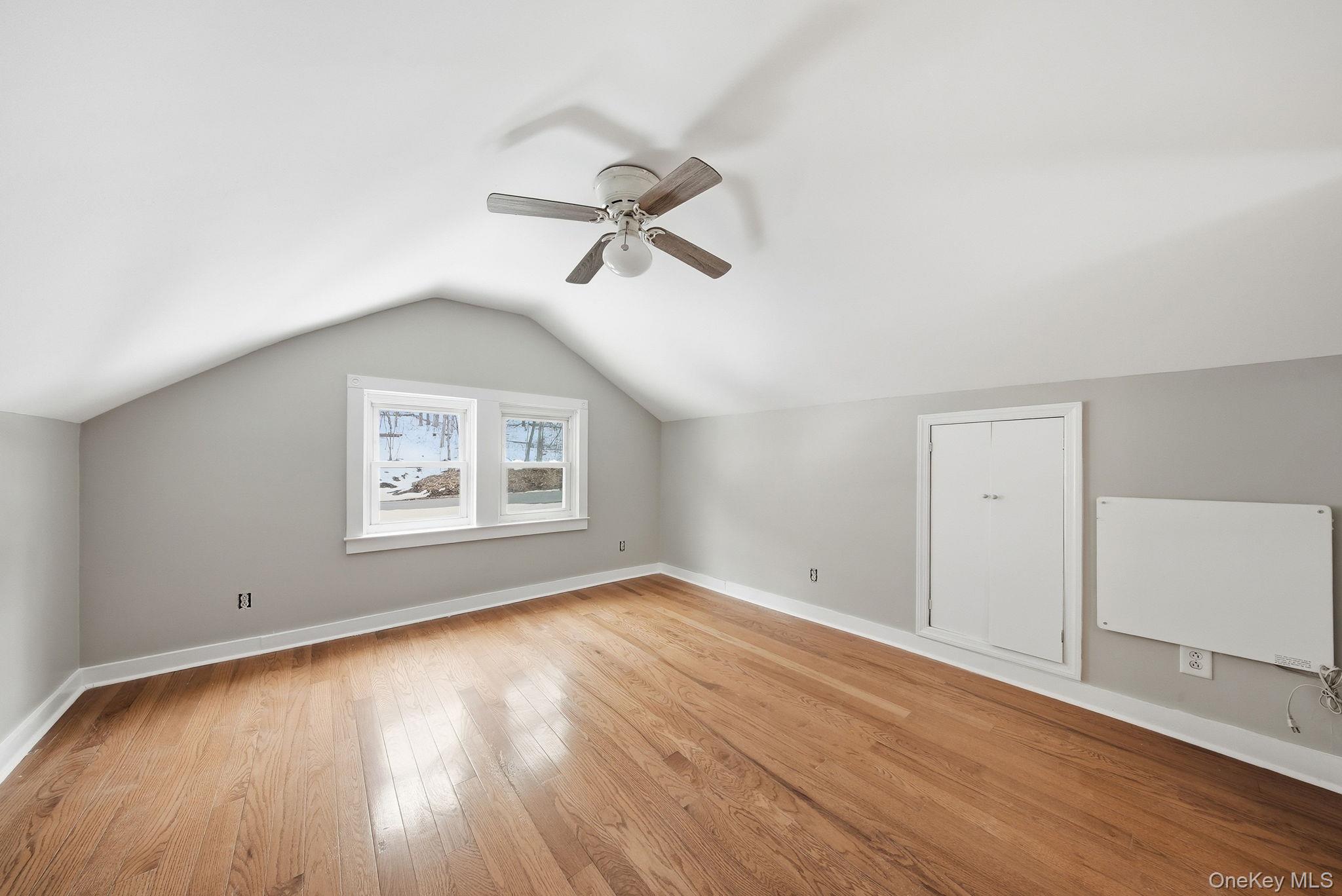 54 Lime Kiln Road Port Jervis, NY 12771 - Photo 12 of 34 an empty room with wooden floor ceiling fan and windows