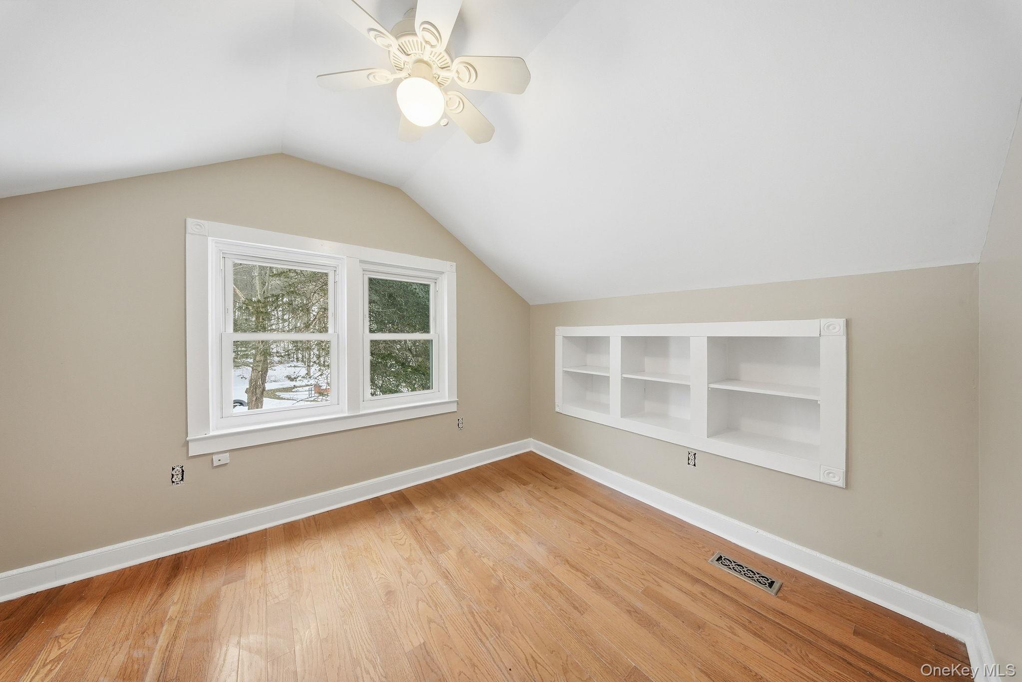 54 Lime Kiln Road Port Jervis, NY 12771 - Photo 13 of 34 an empty room with wooden floor chandelier fan and windows