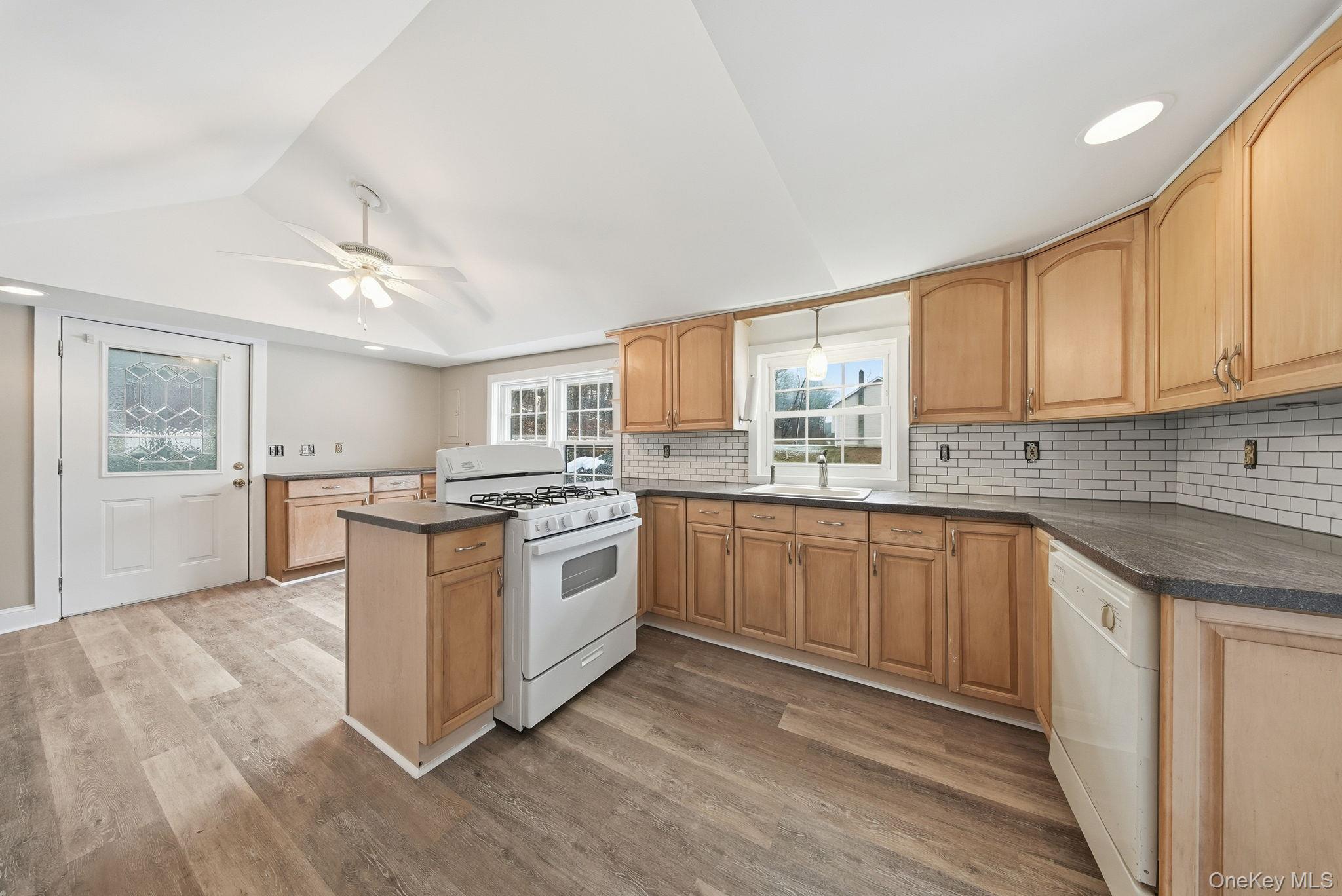 54 Lime Kiln Road Port Jervis, NY 12771 - Photo 24 of 34 a kitchen with a sink cabinets wooden floor and stainless steel appliances