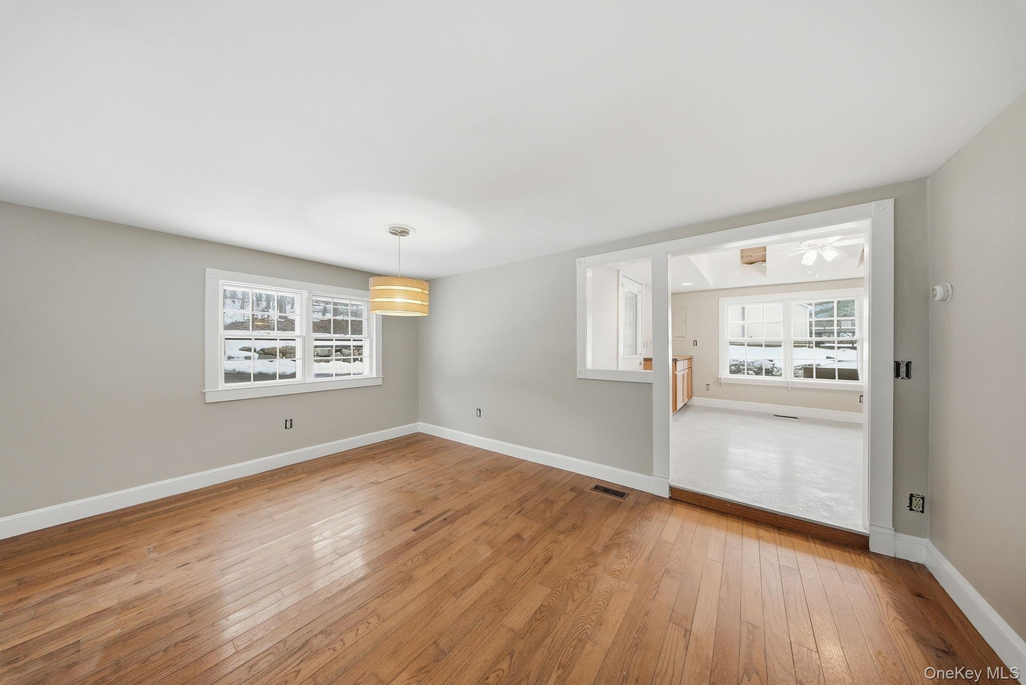 54 Lime Kiln Road Port Jervis, NY 12771 - Photo 6 of 34 an empty room with wooden floor cabinet and windows