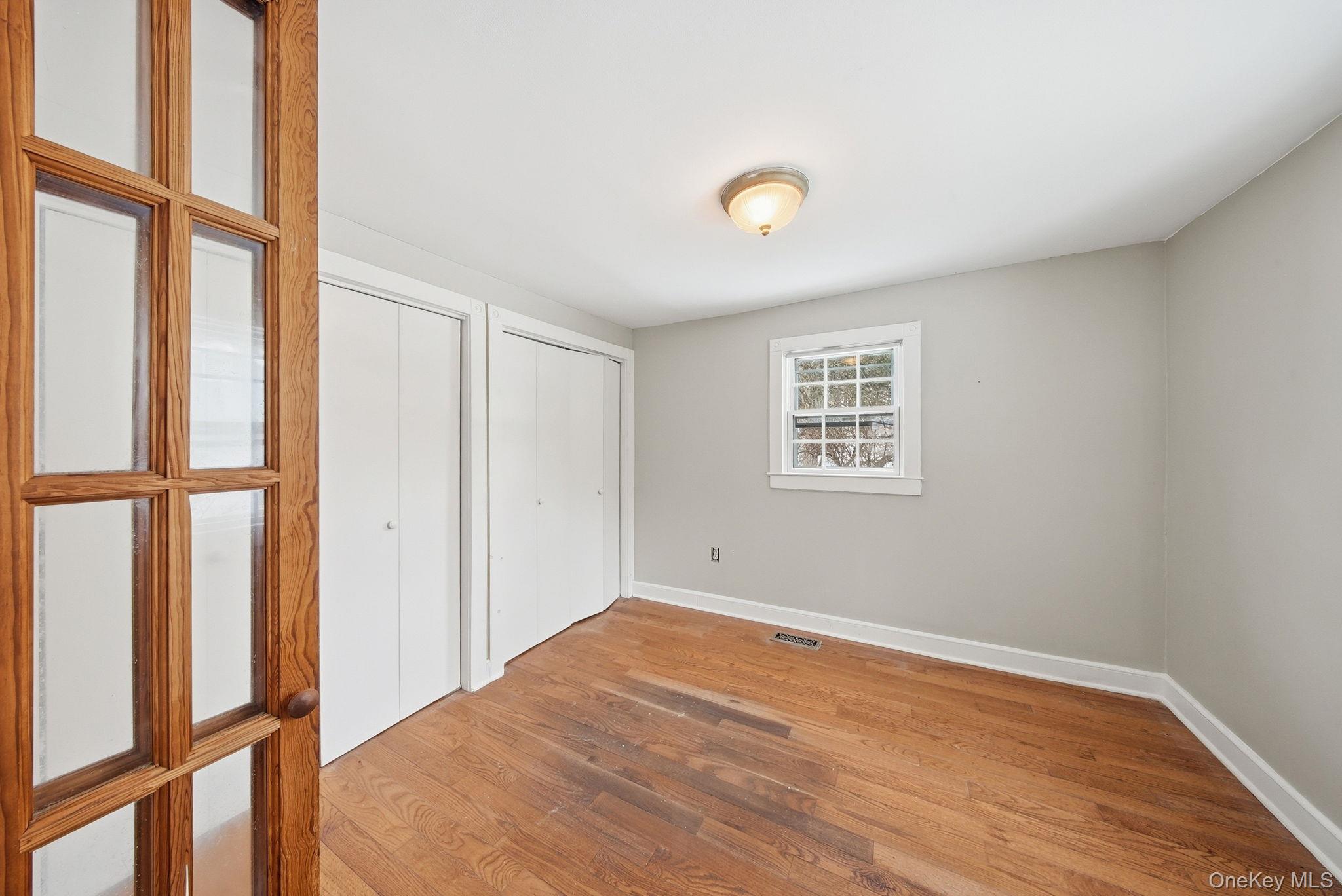 54 Lime Kiln Road Port Jervis, NY 12771 - Photo 8 of 34 a view of an empty room with wooden floor and a window