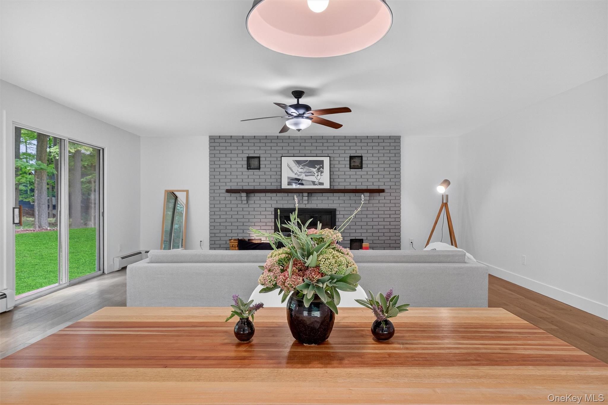 15 Fairview Road Beacon, NY 12508 - Photo 12 of 41 Dining area with light wood-type flooring, a fireplace, a baseboard heating unit, and ceiling fan