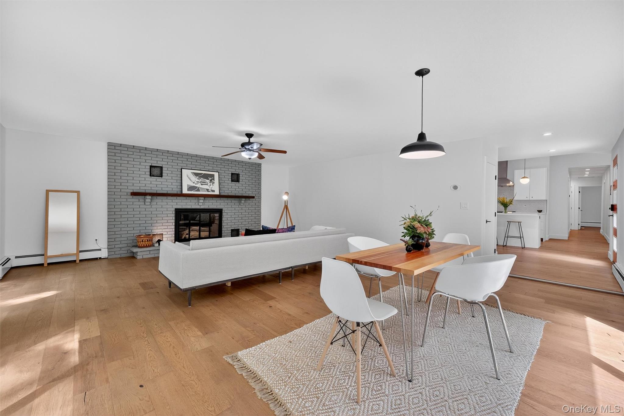 15 Fairview Road Beacon, NY 12508 - Photo 13 of 41 Dining room featuring light wood-style floors, a brick fireplace, ceiling fan, and recessed lighting