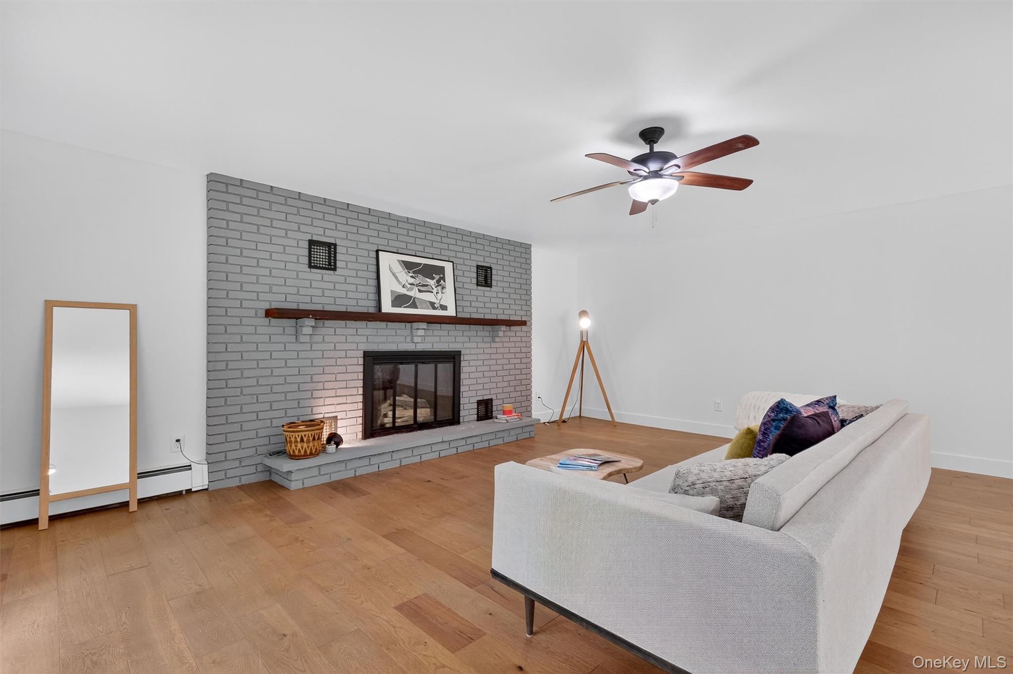 15 Fairview Road Beacon, NY 12508 - Photo 17 of 41 Living area featuring light wood-type flooring, a fireplace, and ceiling fan