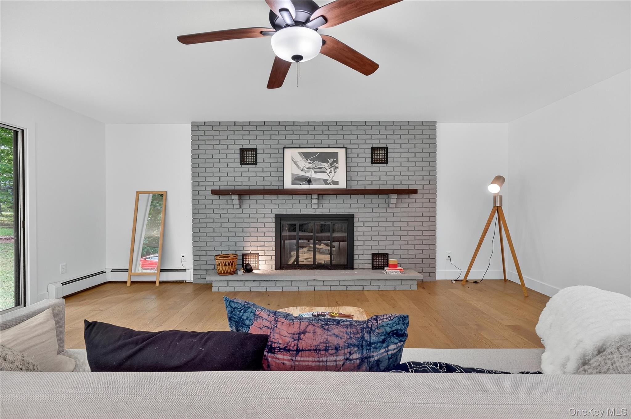 15 Fairview Road Beacon, NY 12508 - Photo 21 of 41 Living room with light wood-style flooring, ceiling fan, a fireplace, and baseboard heating