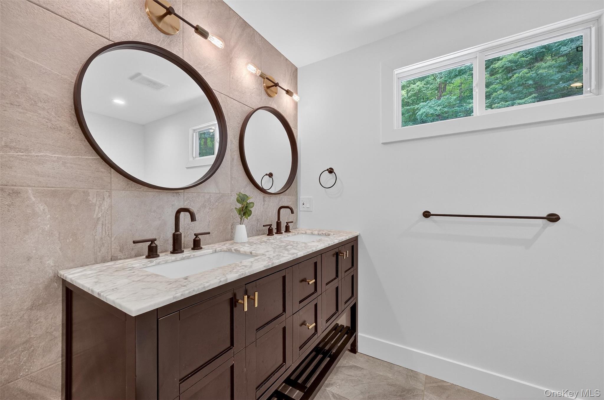 15 Fairview Road Beacon, NY 12508 - Photo 22 of 41 Bathroom featuring double vanity, tile walls, light tile patterned flooring, and backsplash