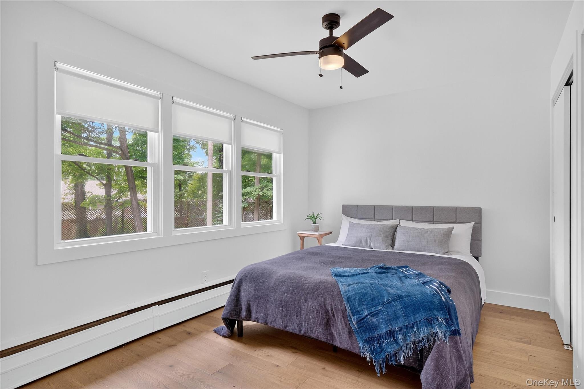 15 Fairview Road Beacon, NY 12508 - Photo 24 of 41 Bedroom featuring baseboard heating, light wood-type flooring, and a ceiling fan