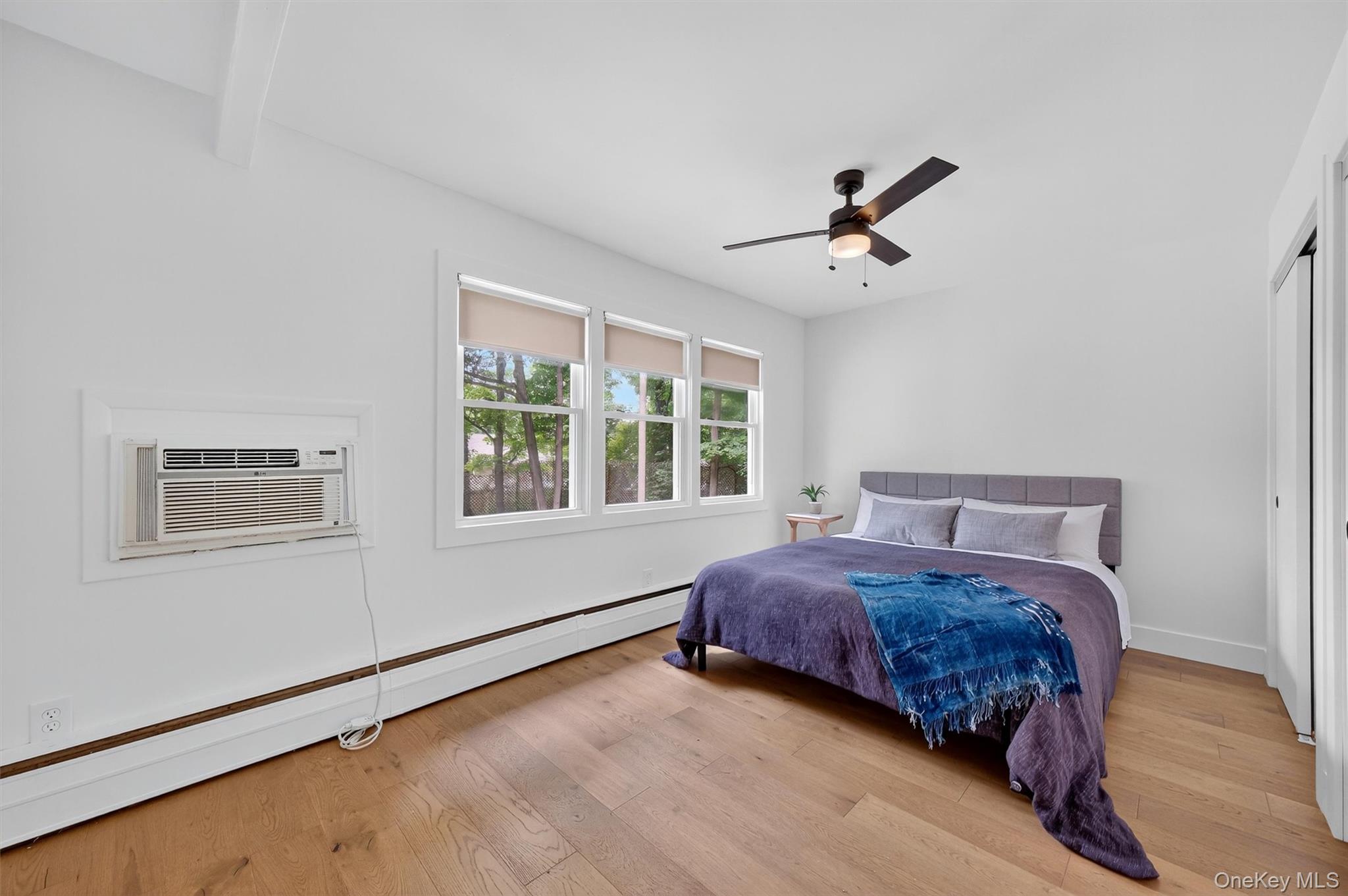 15 Fairview Road Beacon, NY 12508 - Photo 26 of 41 Bedroom featuring a baseboard heating unit, light wood finished floors, ceiling fan, and a wall mounted AC