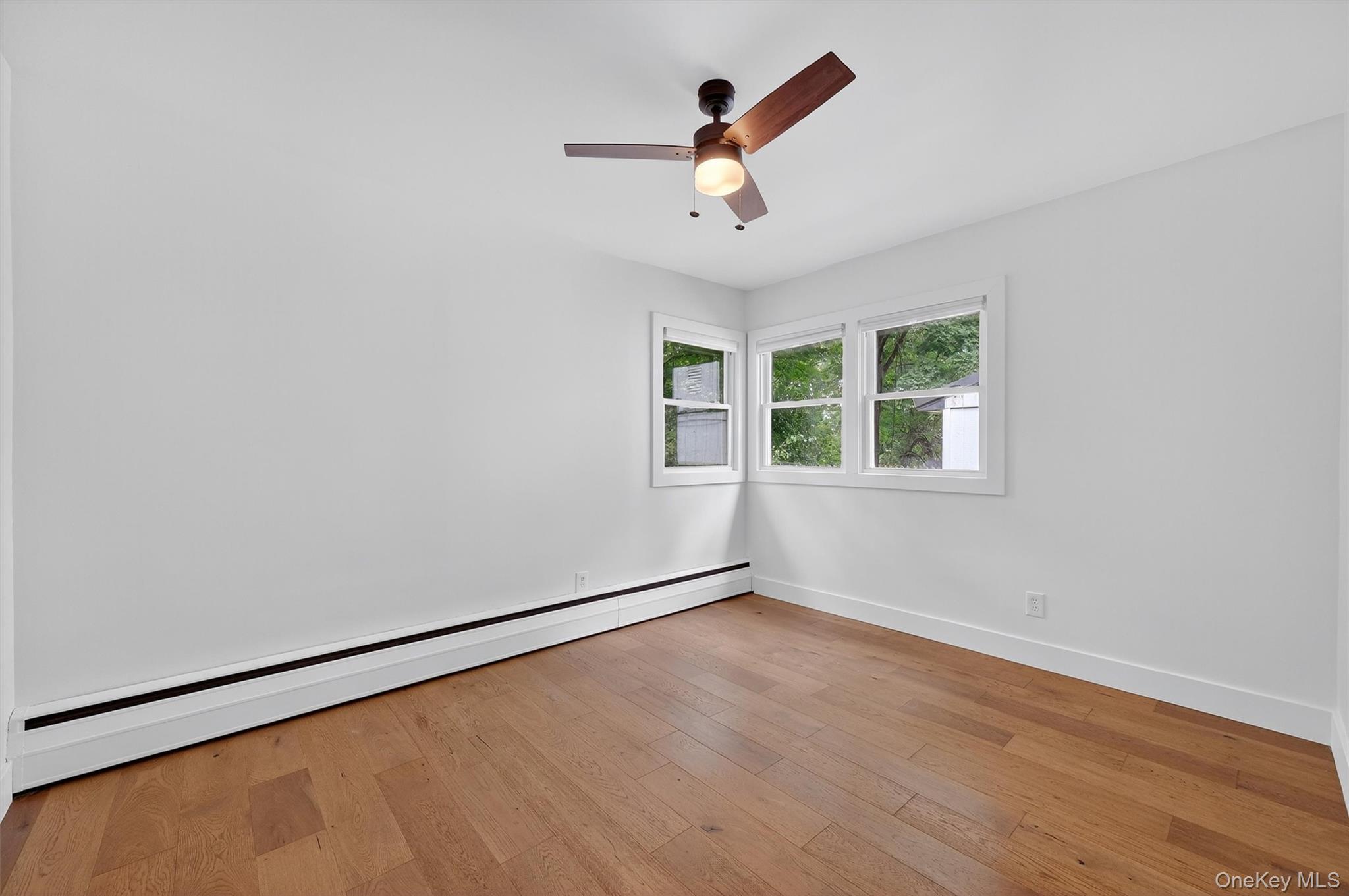 15 Fairview Road Beacon, NY 12508 - Photo 28 of 41 Spare room with a baseboard heating unit, hardwood / wood-style flooring, and a ceiling fan