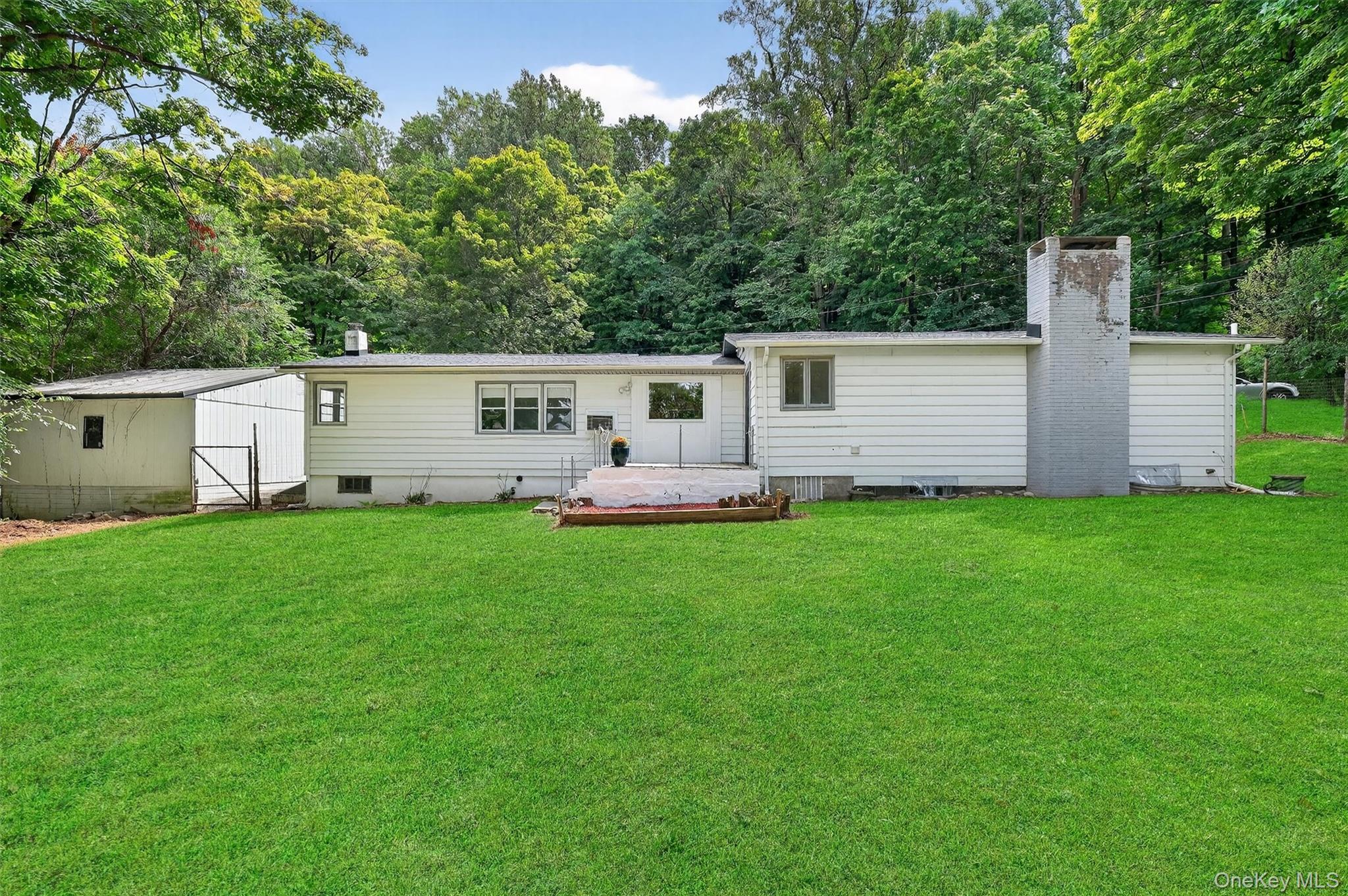 15 Fairview Road Beacon, NY 12508 - Photo 38 of 41 Rear view of property featuring a yard, a chimney, and an outbuilding