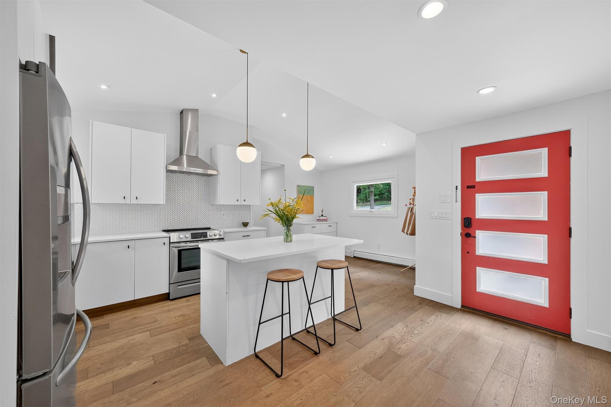 15 Fairview Road Beacon, NY 12508 - Photo 7 of 41 Kitchen featuring a breakfast bar area, a kitchen island, white cabinetry, stainless steel appliances, and tasteful backsplash