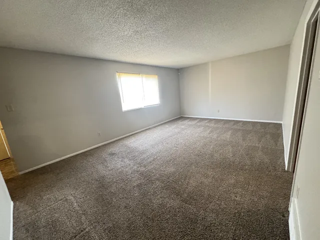 an empty room with windows and dryer