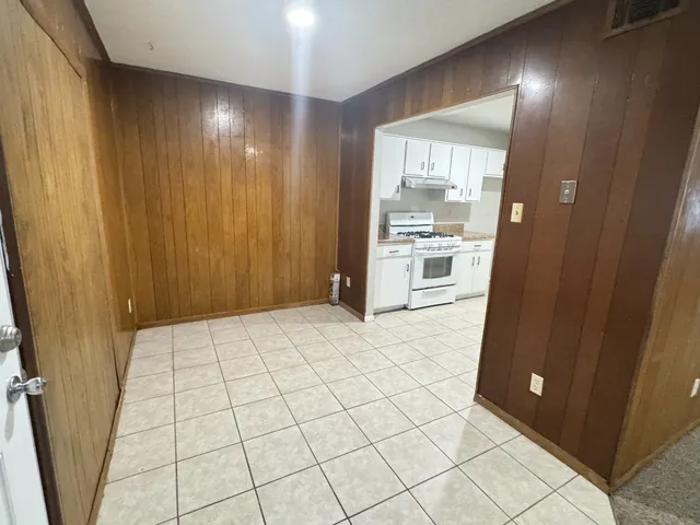 a kitchen with granite countertop white cabinets and white appliances