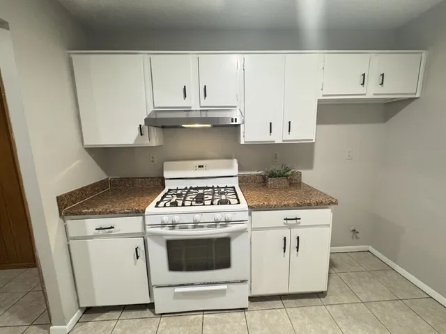 a bathroom with a double vanity sink toilet and shower