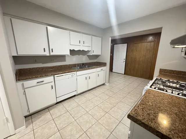 an empty room with fireplace and windows