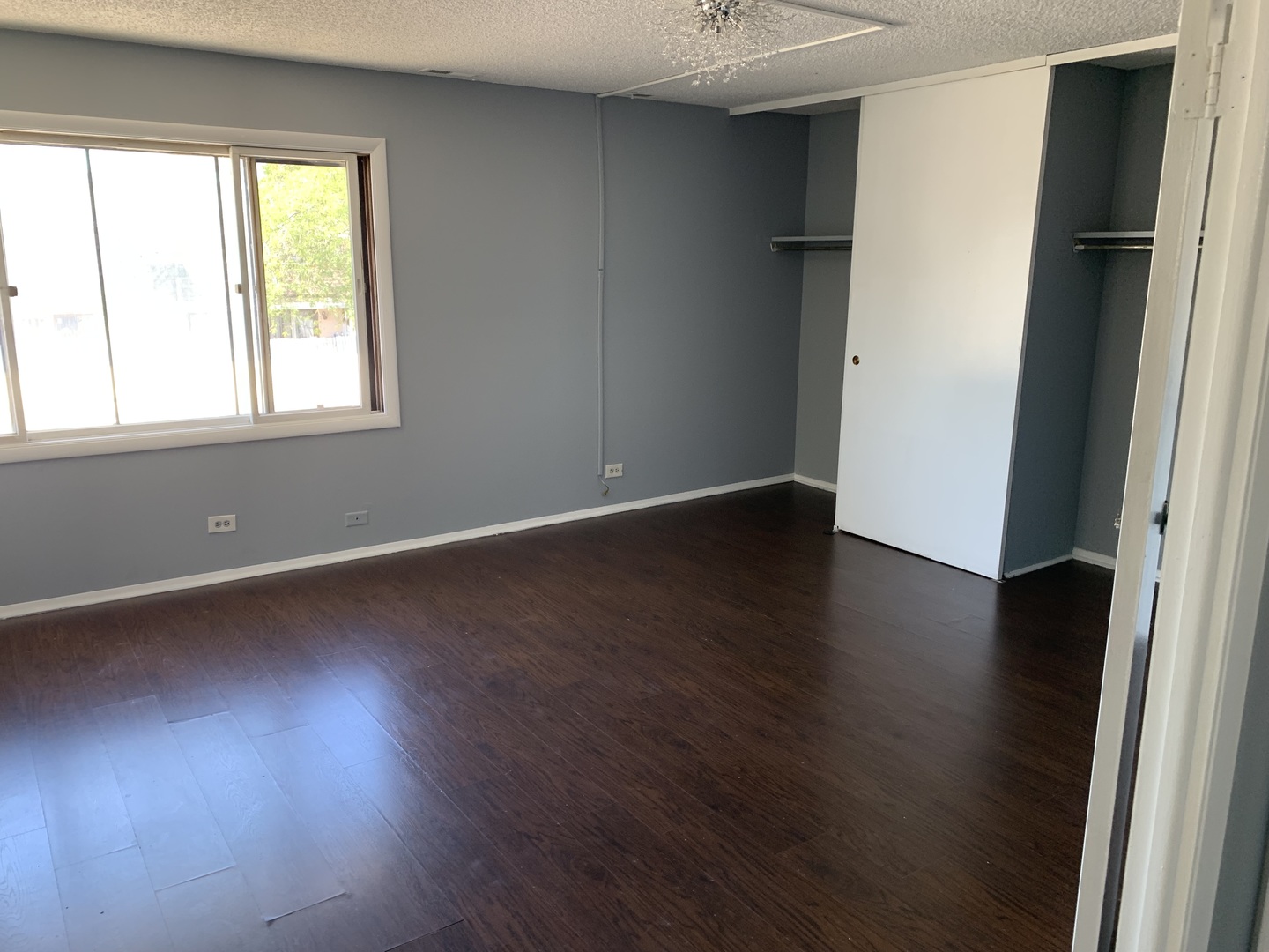 5573 Court F Hanover Park, IL 60133 - Photo 15 of 21 an empty room with wooden floor and a window