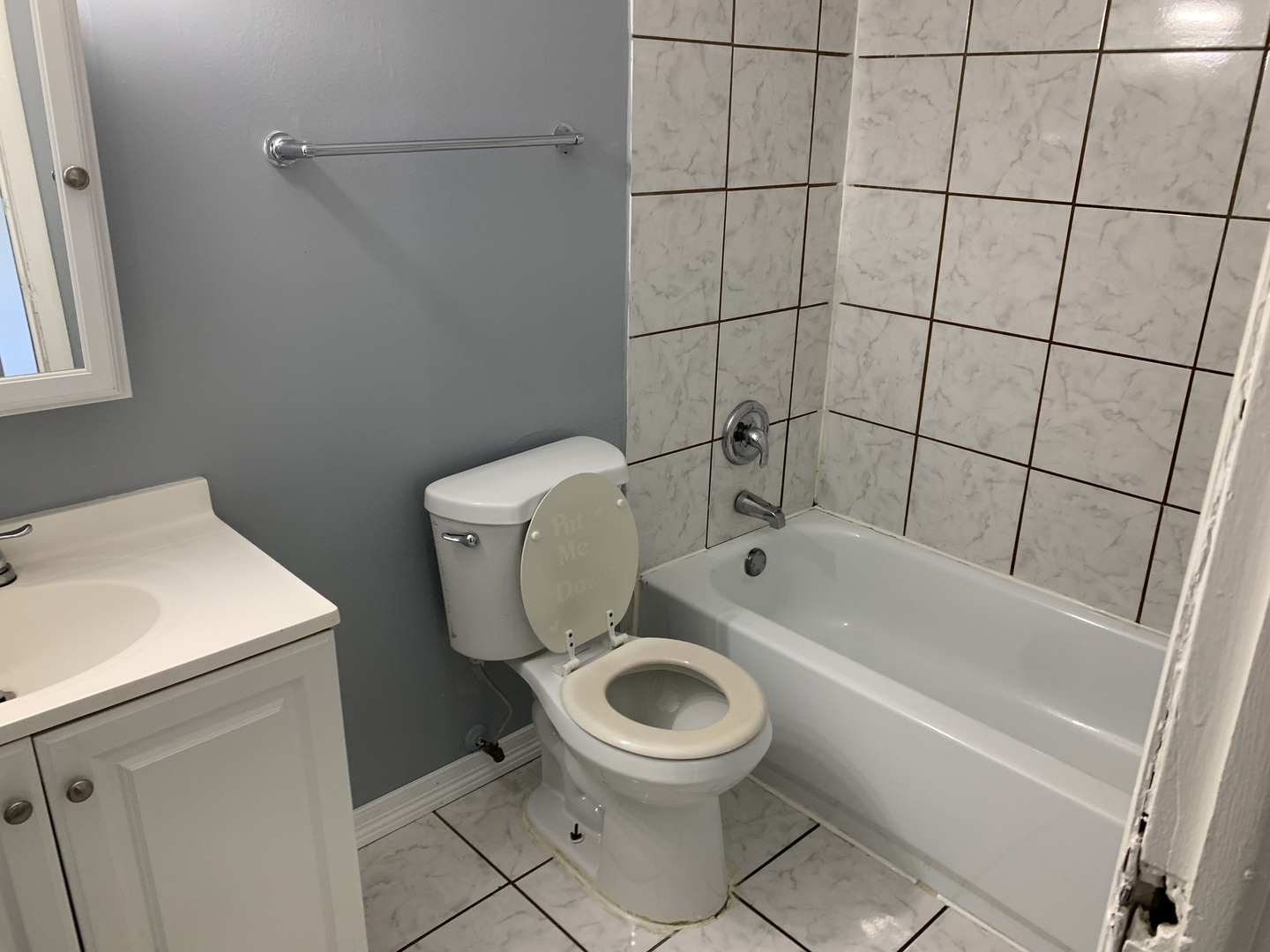 5573 Court F Hanover Park, IL 60133 - Photo 16 of 21 a white toilet sitting next to a bath tub