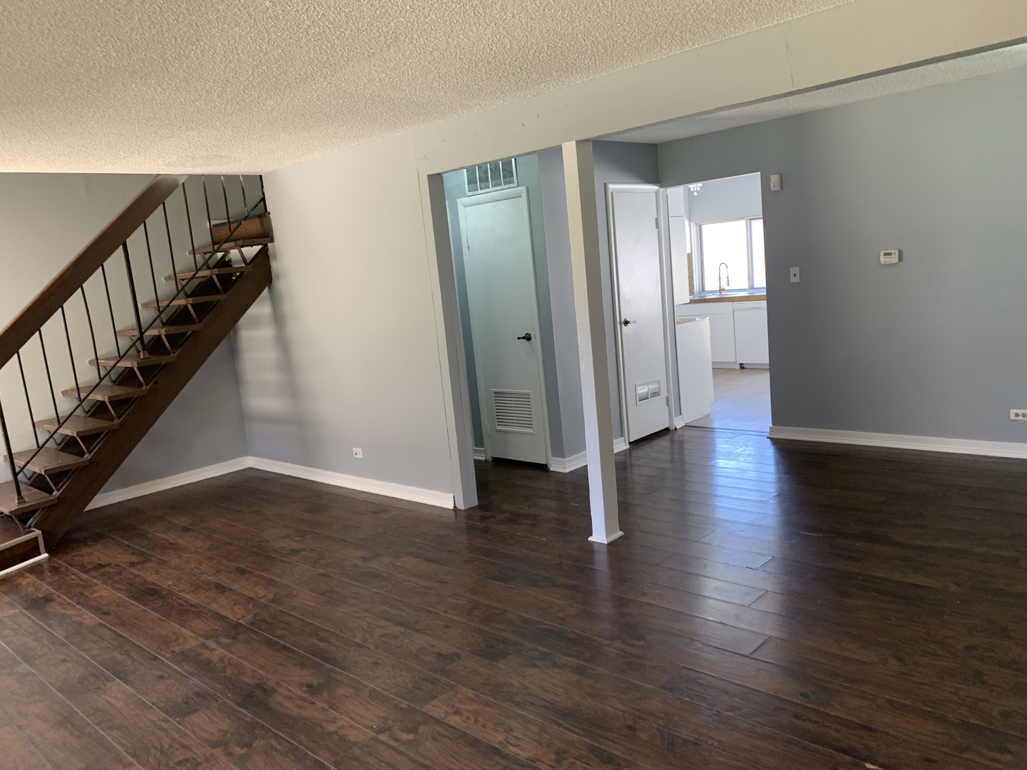 5573 Court F Hanover Park, IL 60133 - Photo 7 of 21 a view of an empty room with wooden floor and stairs