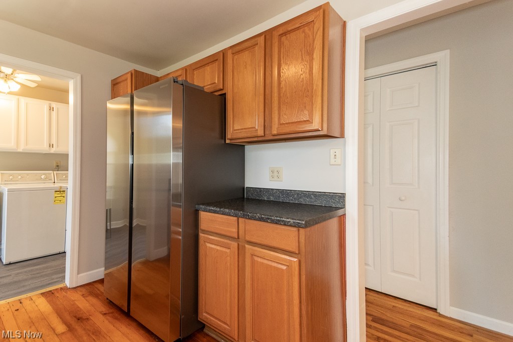 308 Wilson Mills Road Chardon, OH 44024 - Photo 6 of 21 Kitchen featuring light hardwood / wood-style floors, washing machine and clothes dryer, ceiling fan, and stainless steel fridge