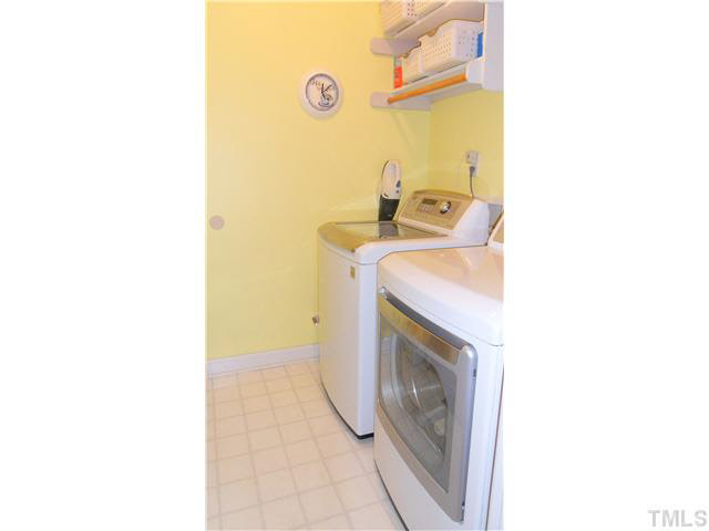 10415 Hallingdale Court Raleigh, NC 27614 - Photo 21 of 25 First floor laundry room right off entrance from garage. Garage has a utility sink and pedestrian side door, as well as two brand new garage doors. Laundry Room