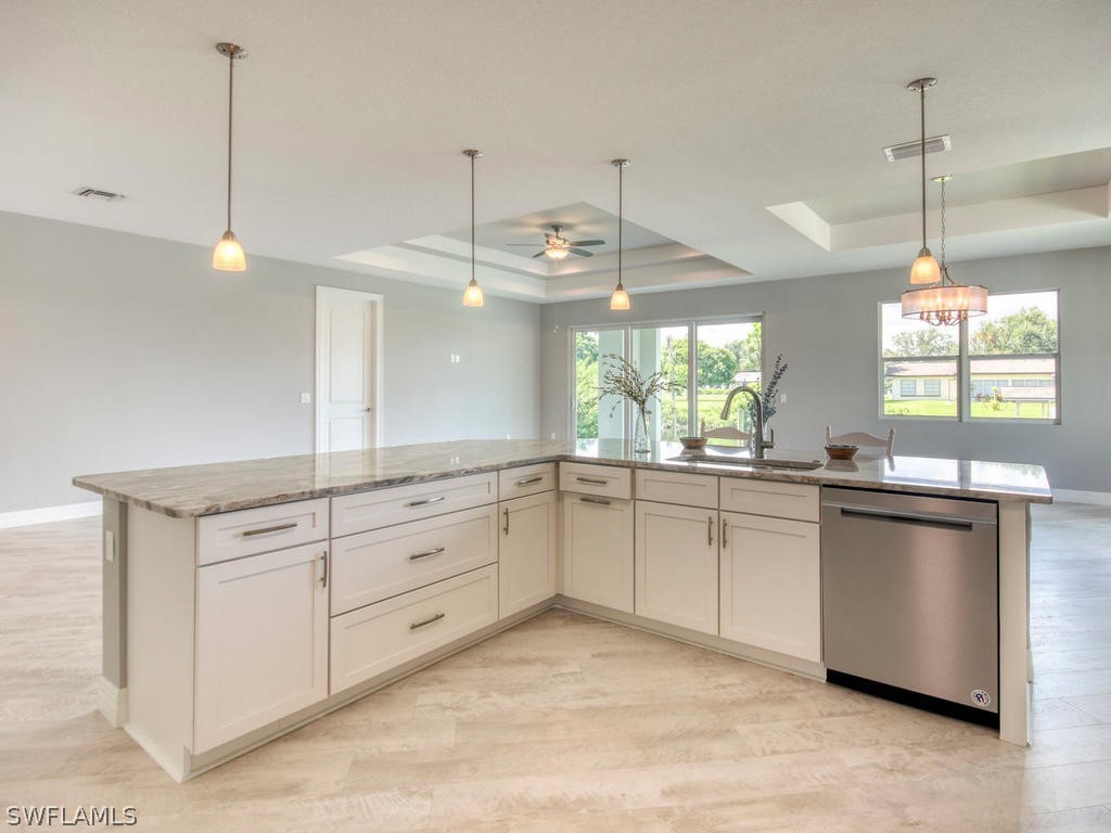 12523 River Road Fort Myers, FL 33905 - Photo 1 of 24 a kitchen with stainless steel appliances granite countertop a stove a sink and white cabinets with wooden floor