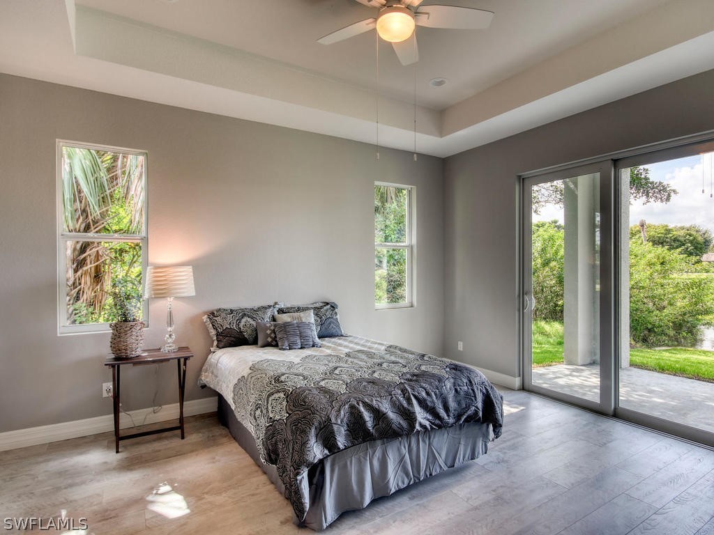 12523 River Road Fort Myers, FL 33905 - Photo 14 of 24 a bedroom with a bed and a chandelier