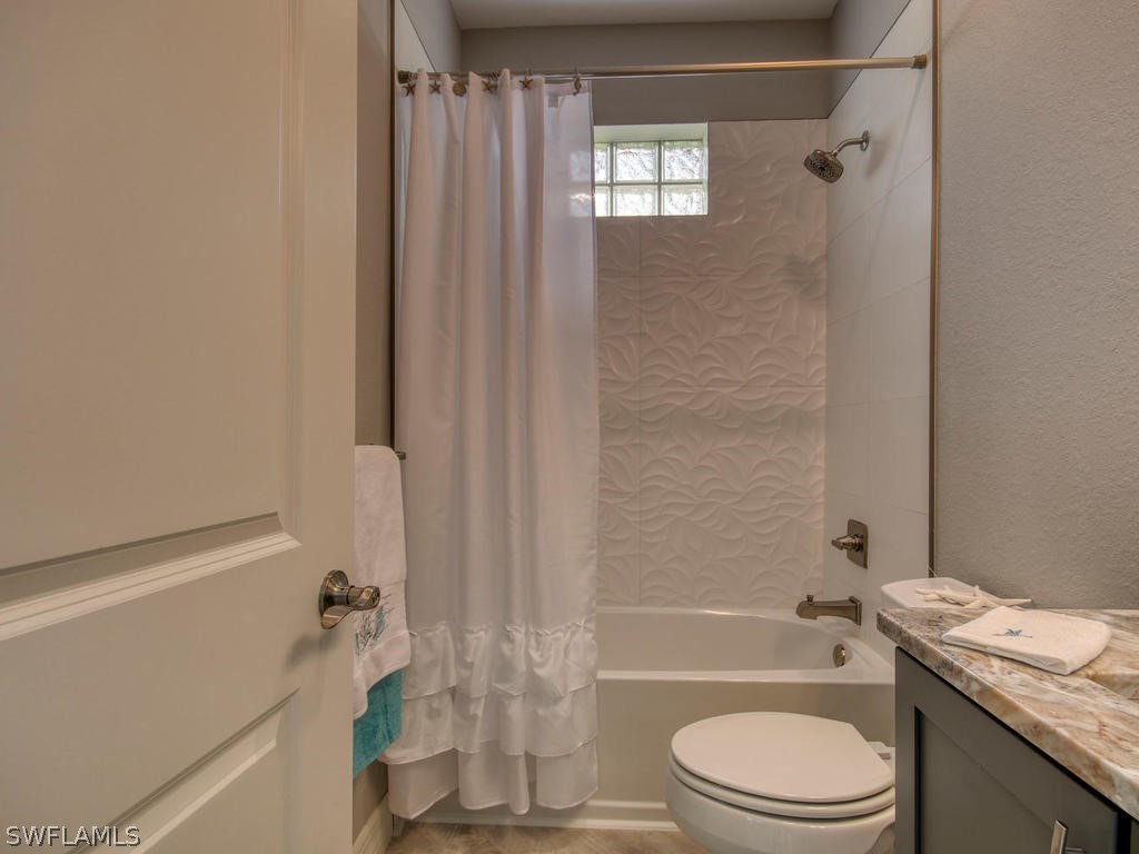 12523 River Road Fort Myers, FL 33905 - Photo 15 of 24 a bathroom with a granite countertop bathtub toilet and sink